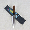Akifusa Aogami Super 135mm Petty (Utility) Kitchen knife resting across the packaging showing the Japanese Kanji and Cherry Blossom tree