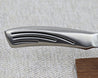 Fit Line 180mm Gyuto (Chef) knife on stand, close up of handle. All Stainless-steel kitchen knife made in Japan