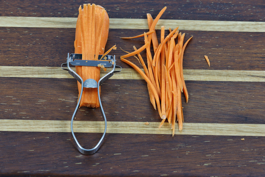 Shimomura Prograde Stainless Steel Julienne|Kinpira Peeler in use on a carrot showing the size of the cut