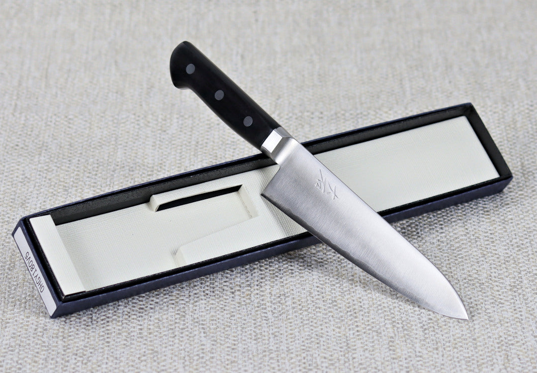 Ohishi VG5 Migaki 180mm Gyuto (Chef) Japanese kitchen knife resting on an angel across packaging