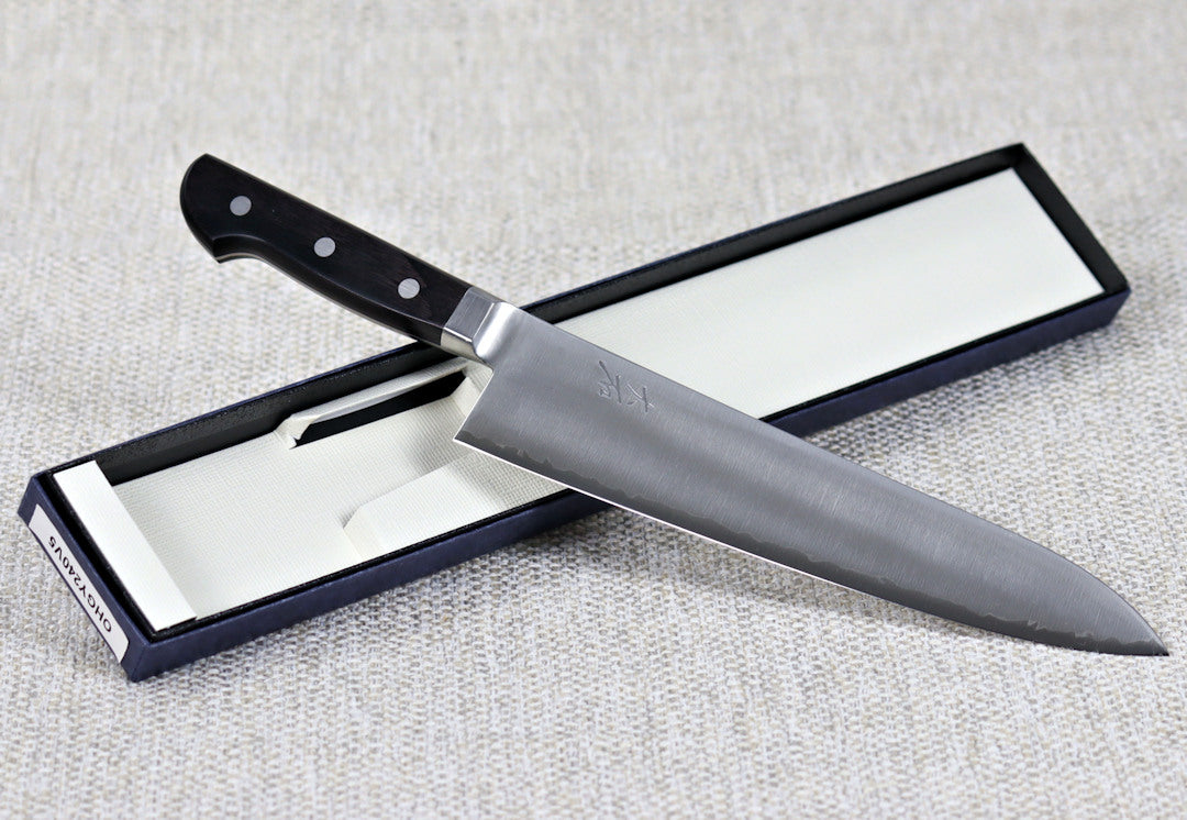 Ohishi VG5 240mm Gyuto (Chef) Japanese kitchen knife angled across packaging