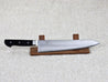 Ohishi VG5 240mm Gyuto (Chef) Japanese kitchen knife resting on a red wood stand