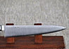 Ohishi VG5 Petty (Utility) Japanese kitchen knife close up of the blade whilst knife is resting on a red wood stand