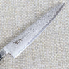 Ohishi Classic Powder Metal Damascus 150mm Petty (Utility) Japanese kitchen knife close up of the "Floating Ink" Damascus blade and the makers mark on the blade