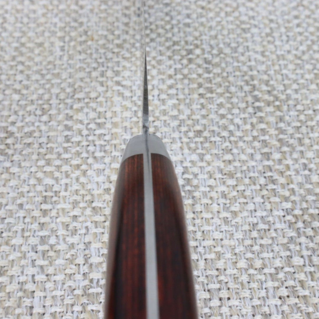 Ohishi Damascus Gyuto (Chef /Cook) hand made Japanese Kitchen knife with the picture looking along the bottom of the handle to show the narrow profile of the knifes bevel approximately 3mm at the handle down to .05mm near the edge.